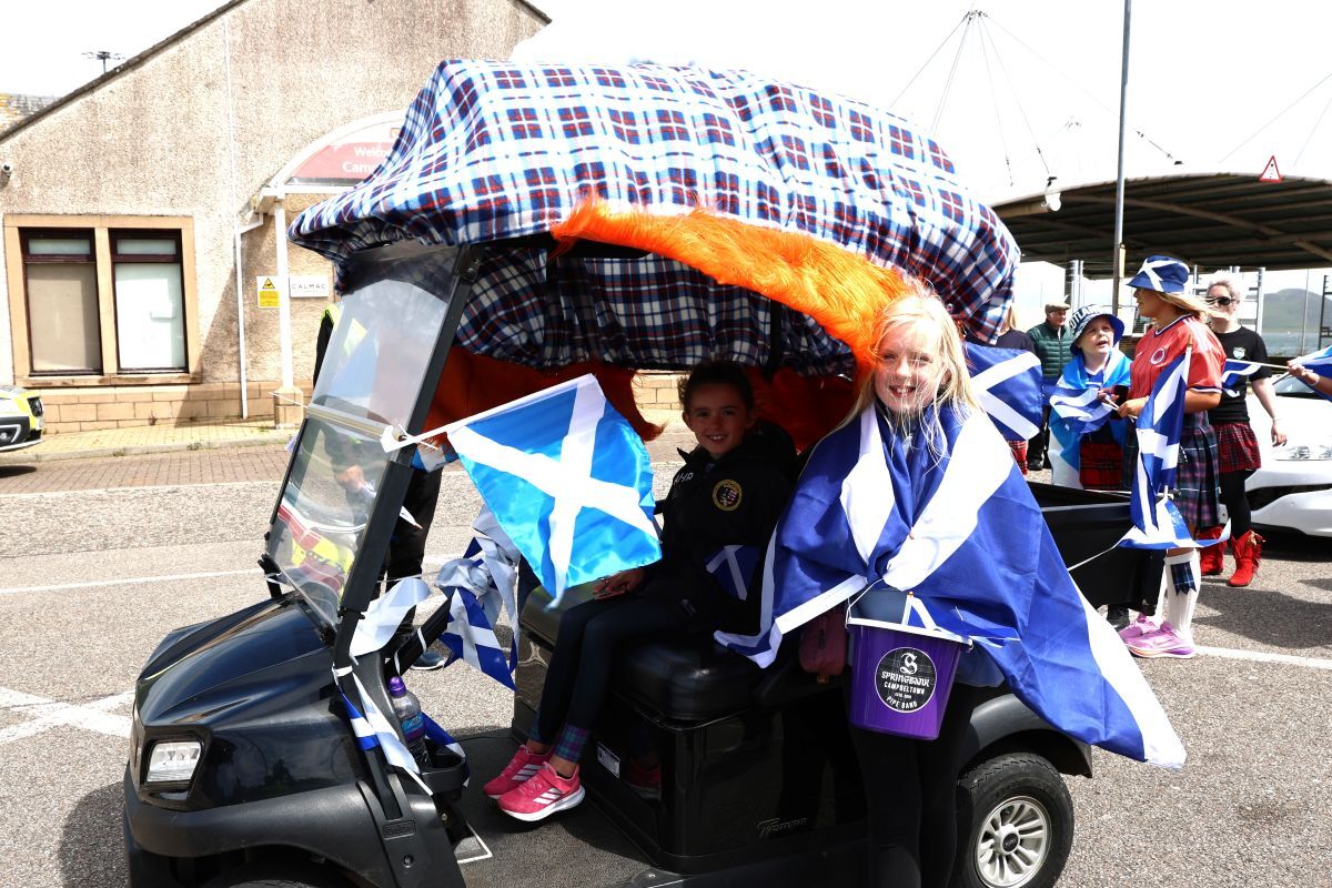 Sisters Emma and Amy Ramsay collected donations for Springbank Campbeltown Pipe Band from a golf cart decorated for the World Cup Bash. Photograph: Kenny Craig. Sisters Emma and Amy Ramsay collected donations for Springbank Campbeltown Pipe Band from a golf cart decorated for the World Cup Bash. Photograph: Kenny Craig.