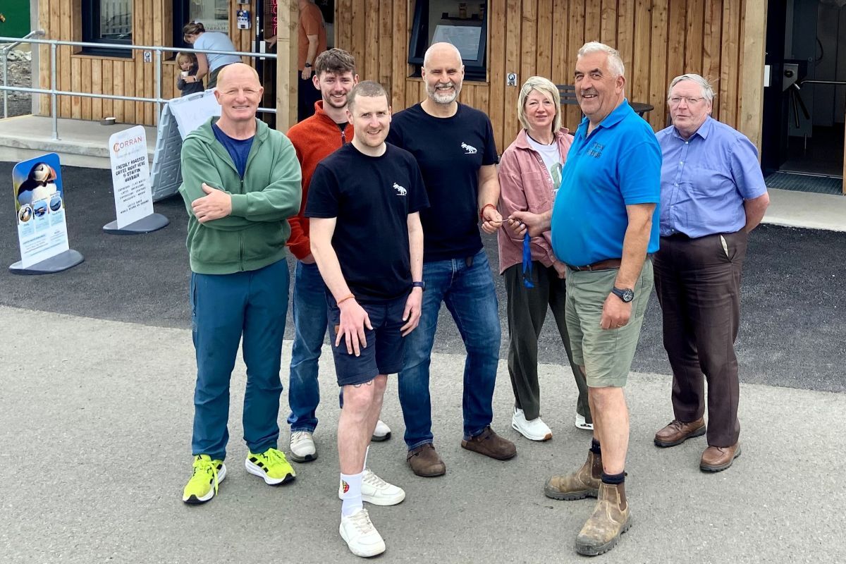 Staffin Harbour manager Lachie Gillies hands over the keys to Corran Coffee's Andi Dunkel and Paul Milne, with SCT directors looking on. 