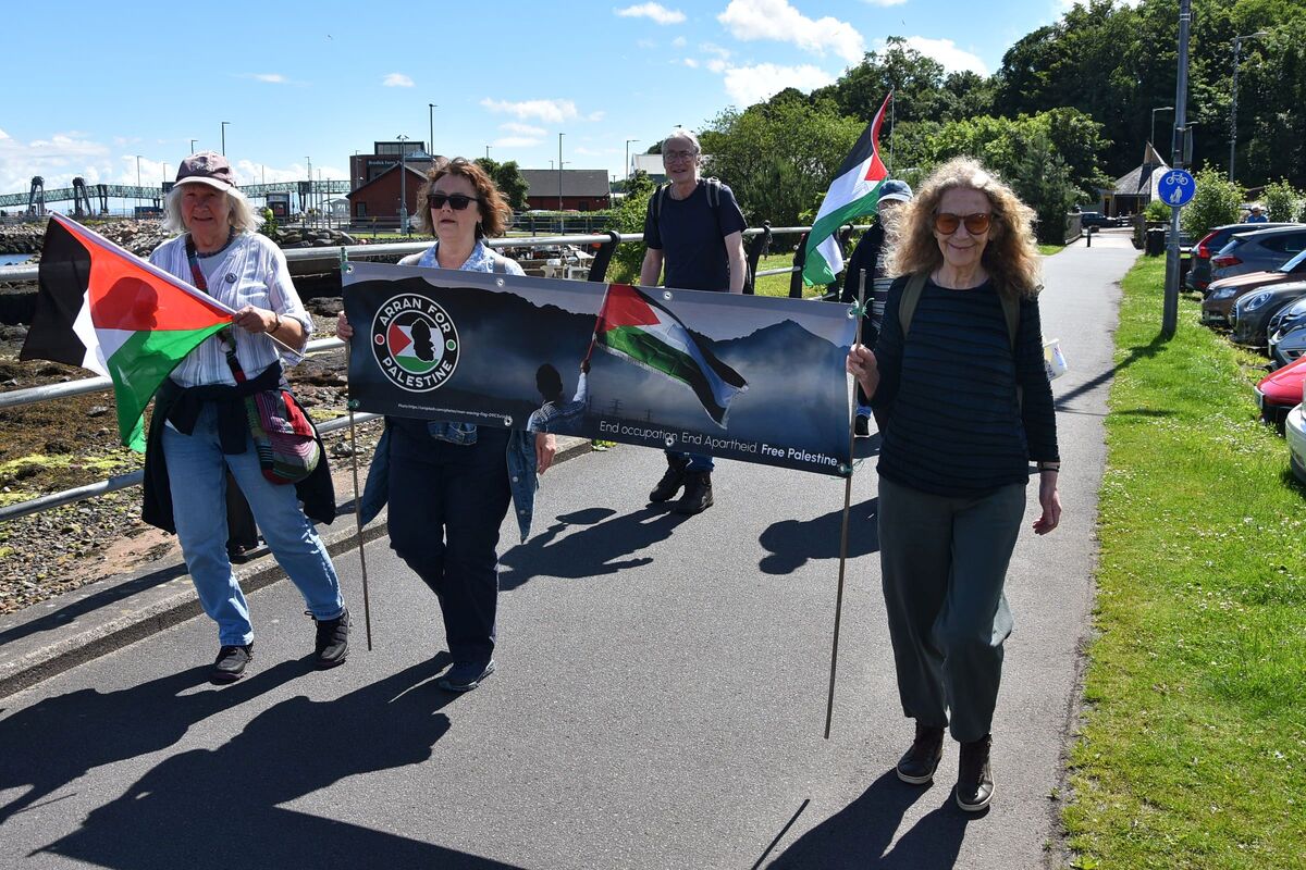 Arran for Palestine supporters march down Brodick’s main road as part of the Stride for Palestinians fundraising initiative.