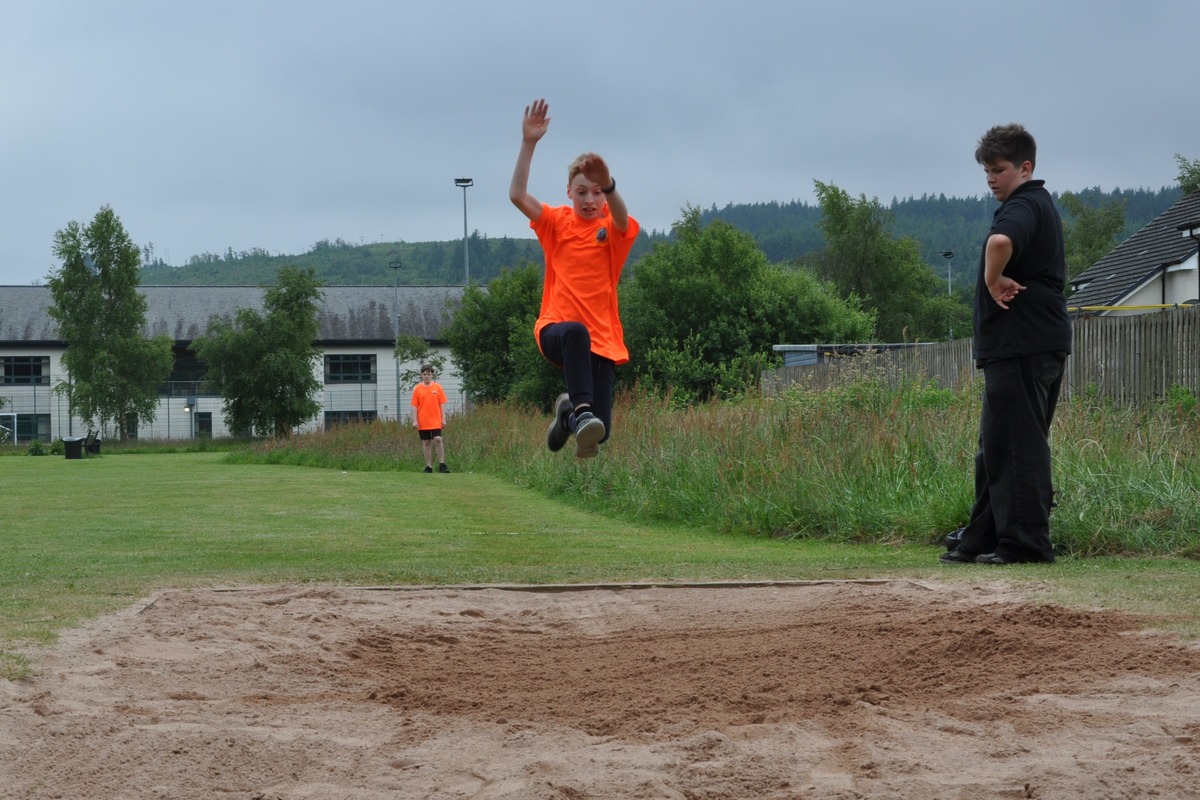 Concentration is evident on the face of this long jump finalist as he flies through the air.