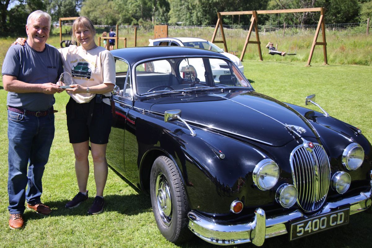 Colin Scott winner of car of the show with his 1961 Jaguar 240, pictured alongside Jana Navratilova from Corachie garden centre. Photograph: Kevin McGlynn