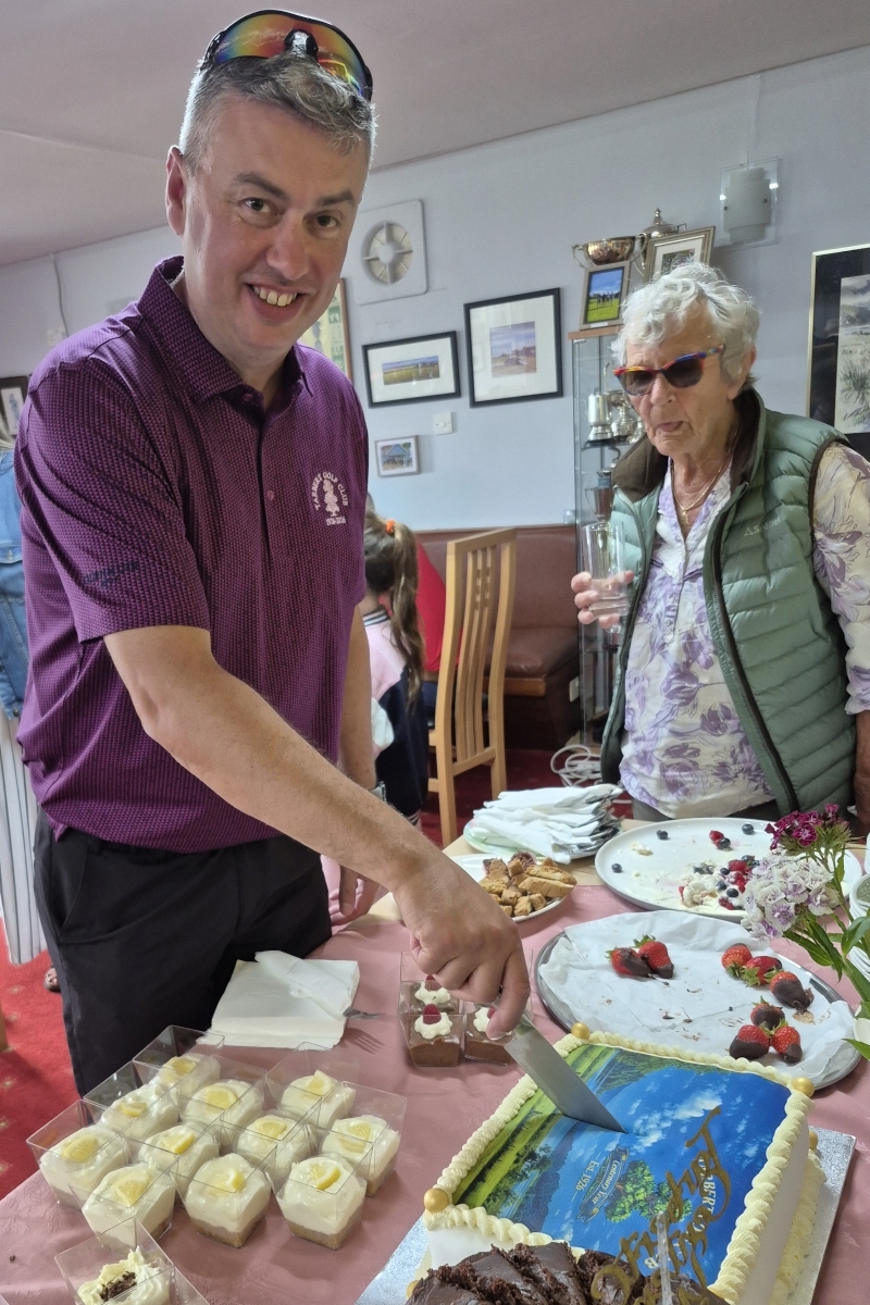 Tarbert Golf Club captain Andrew Henderson cuts the centenary celebration cake.