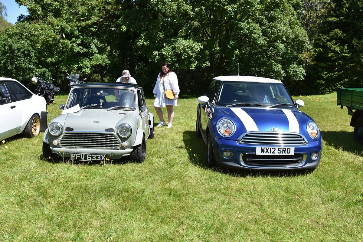 An “old style” Mini fitted with a two litre Honda Civic engine and a modern Mini made by BMW.