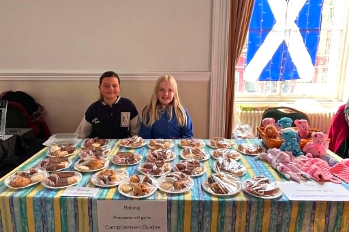 Guides Eva McFadyen and Emma Ramsay helping on the baking stall.