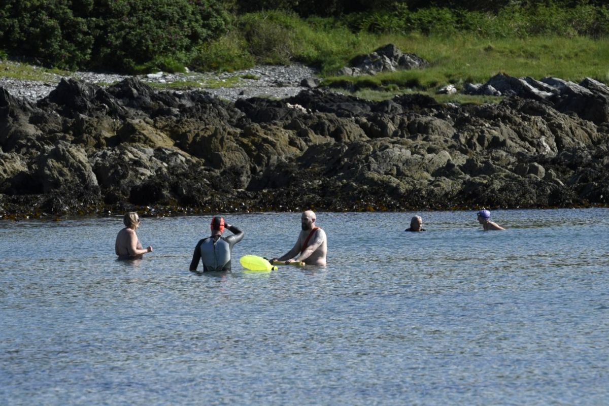 Professional open-water swim coach and wild swimming guide ‘Swim Dan the Merman’ led sessions at Port Righ, taking advantage of glorious weather and calm seas. Photograph: Kyle King.