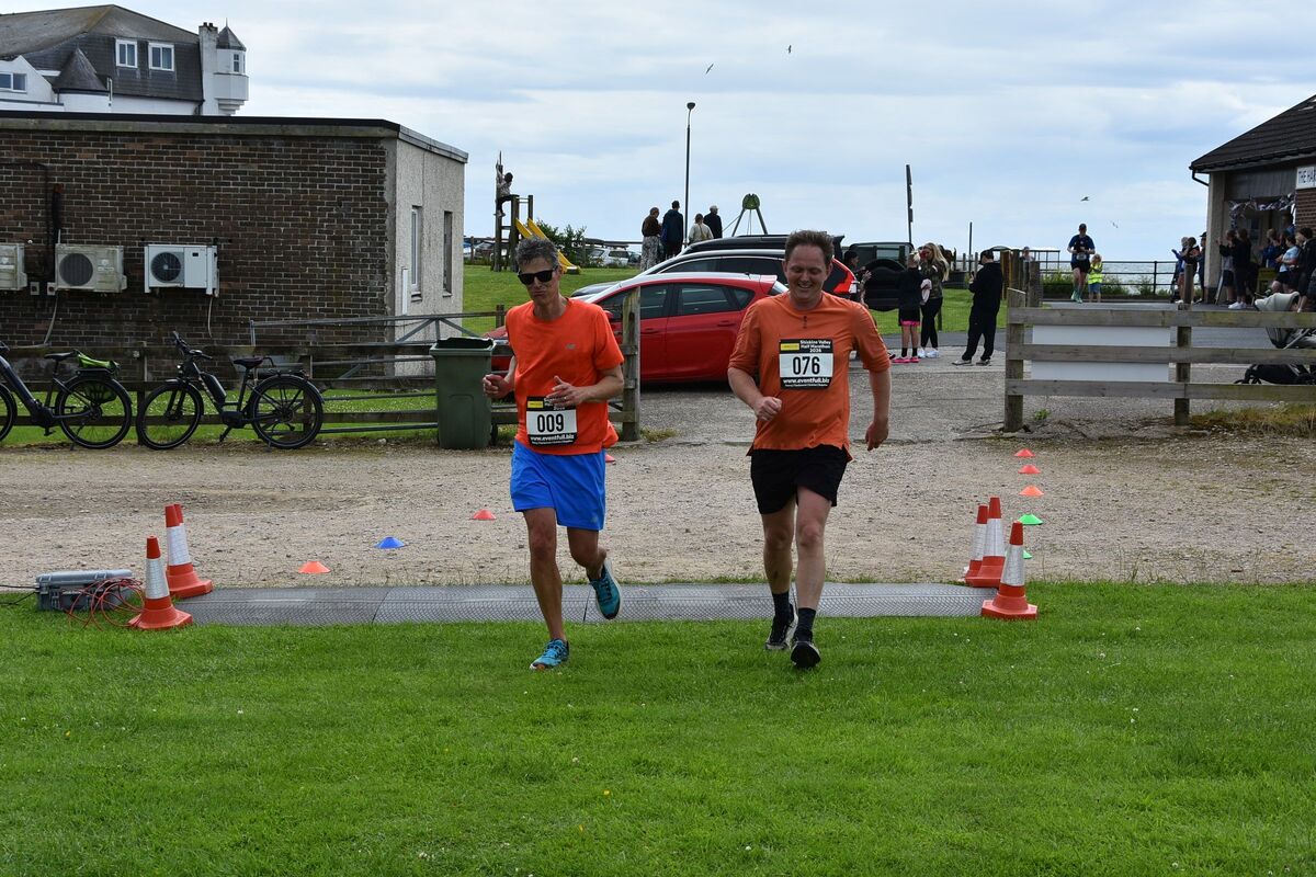 Locals Richard Bowen and Robert McNeice cross the finish line.
