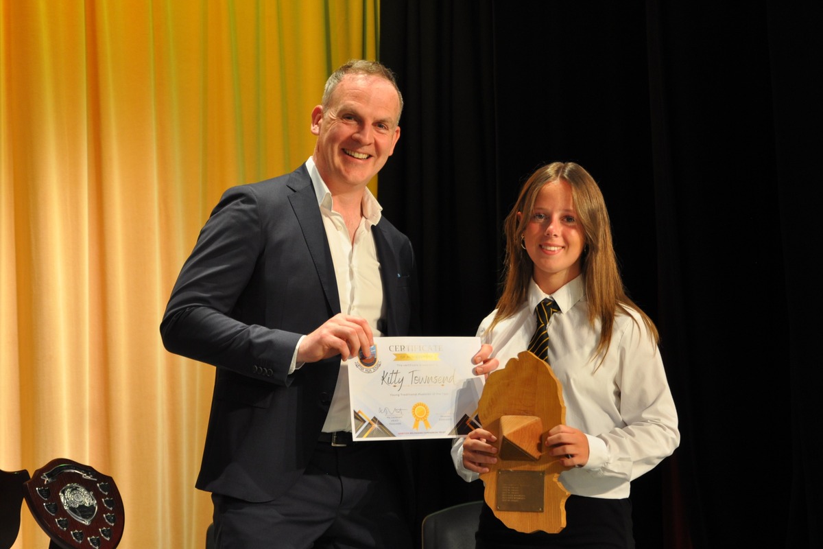 Young Traditional Musician of the Year, Kitty Townsend, receives her award from guest speaker, Stuart Watts.