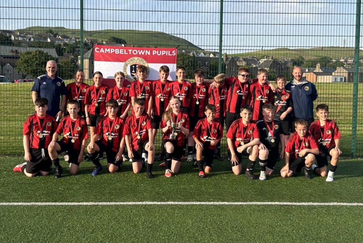 The triumphant CDJFA 2013s celebrate winning the Argyll League Cup with coaches Martin Brown, back left, and George Pope, back right.