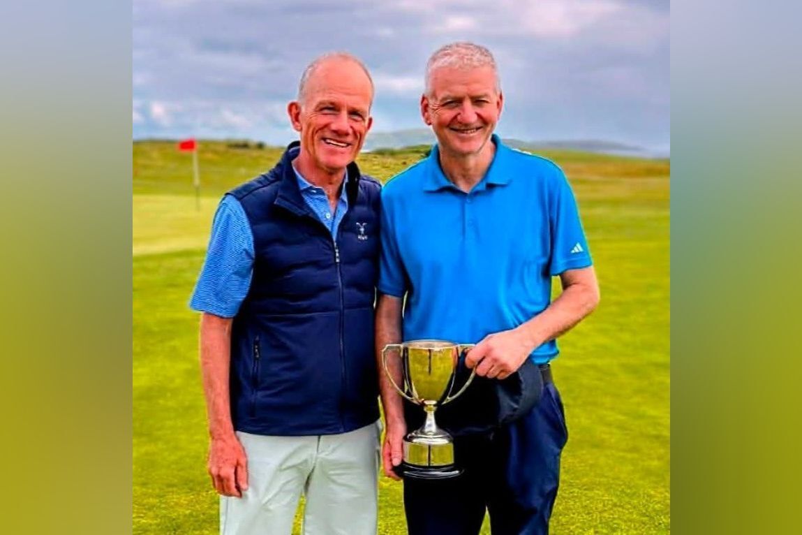 Gents' 2026 gents' club champion and seniors champion George MacMillan, right, receiving the trophy from club captain Douglas Neilson.