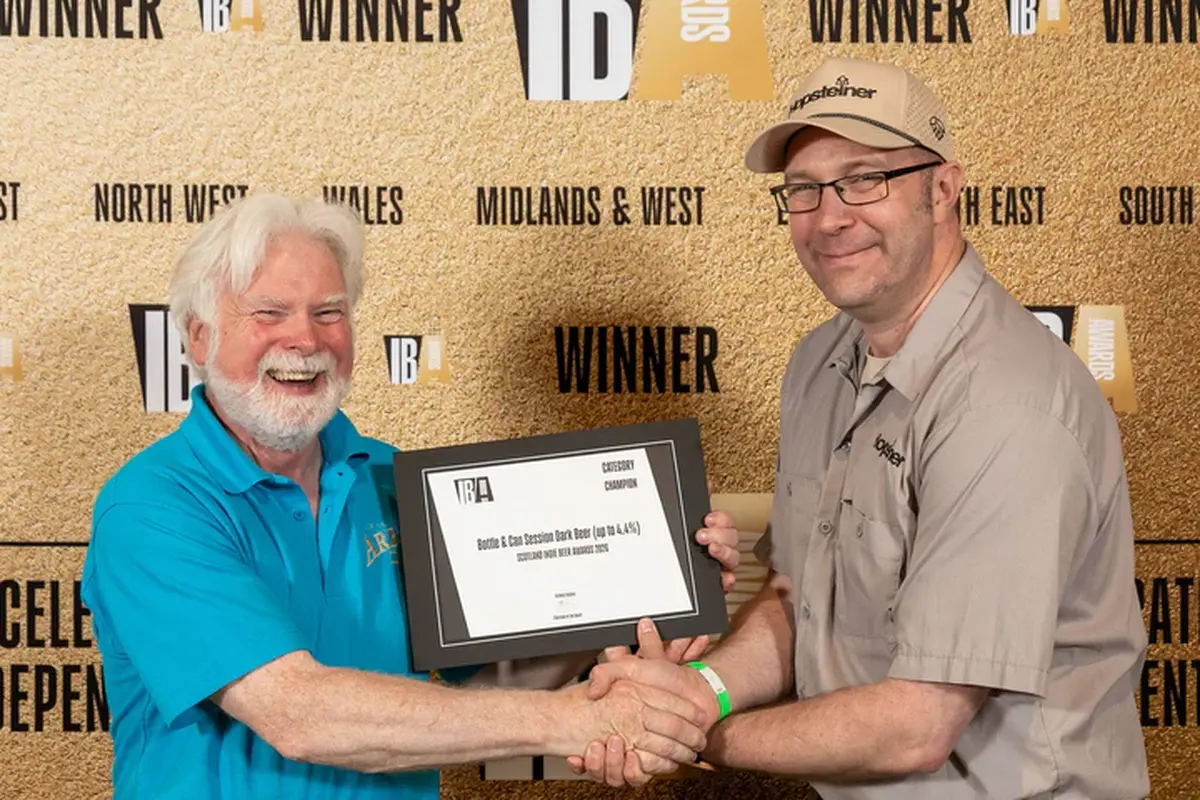 Neil Walker, head of communications at SIBA, presented Arran Brewery&rsquo;s Gerald Michaluk with the category champion award won by Arran Dark at the regional event last week. Photograph: Arran Brewery.