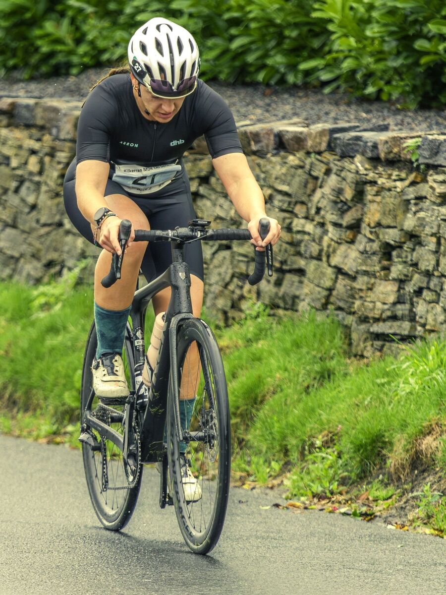 Ladies’ winner Kirsty McMillan powers through the bike leg on her way to setting a new course record. Photograph: John Coffield.