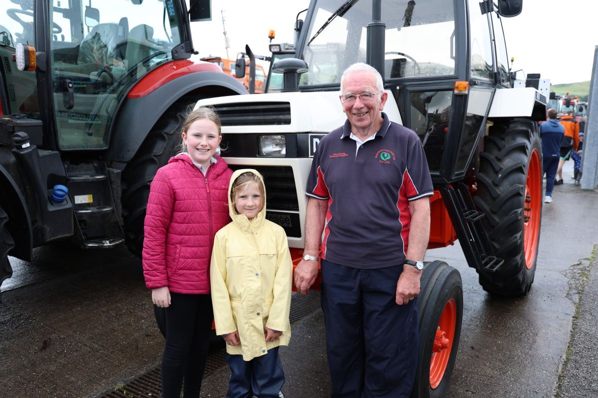 Jackie Morrison, whose vehicle was named best vintage tractor, with two young admirers during the stop at Campbeltown Ferry Terminal. Photograph: Kenny Craig.