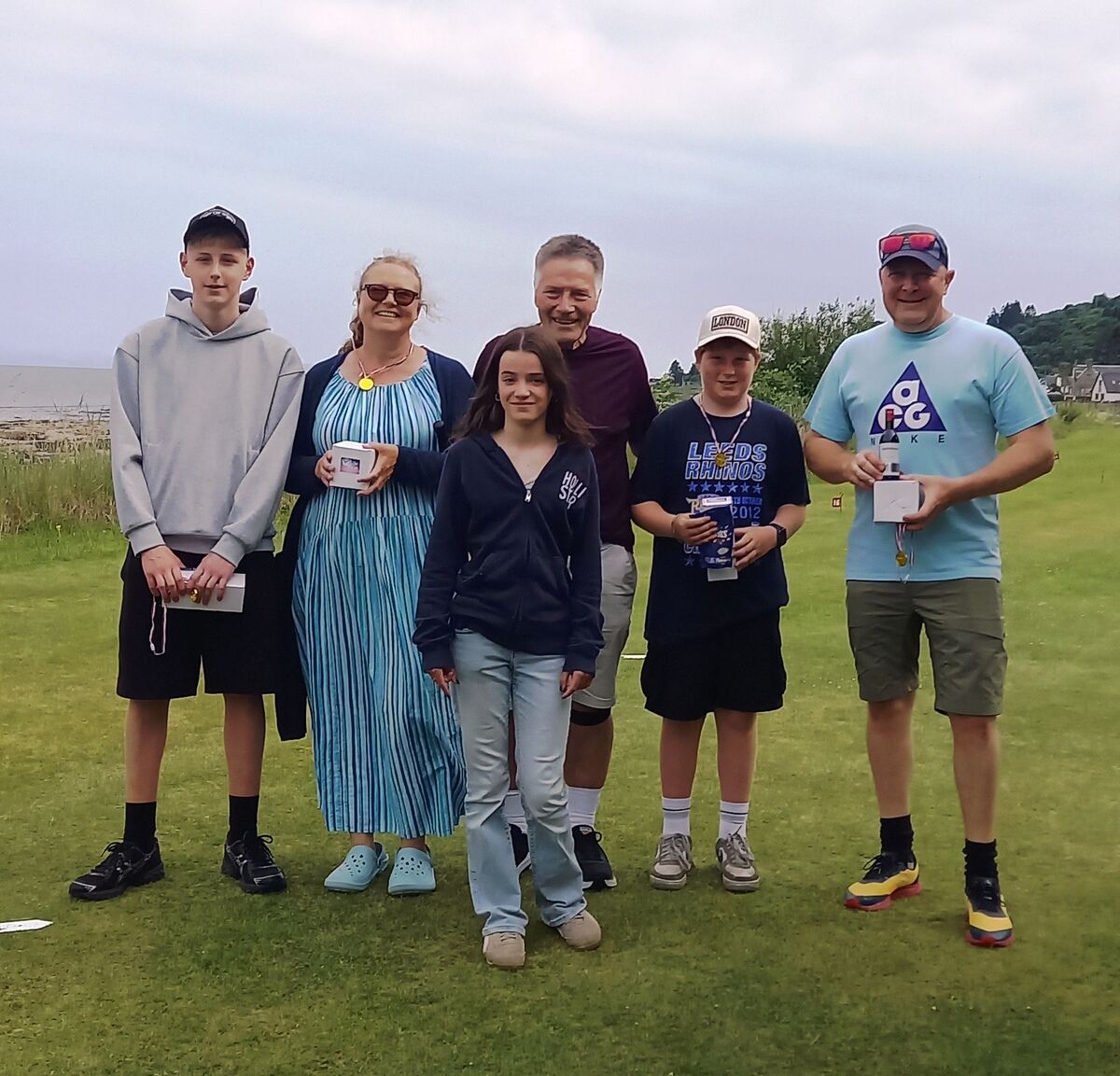 Bay Queen, Astrid Hamade with putting competition prize winners: Harris Gillespie, Mairi Stewart, Peter Towndrow, Frankie Lucas, and David Mack. Photograph: Supplied. 