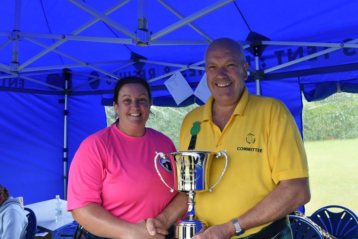 Donald McKelvie presents overall ladies heavy events champion, Mhairi Porterfield, with the A McKelvie Cup. Donald McKelvie presents overall ladies heavy events champion, Mhairi Porterfield, with the A McKelvie Cup.