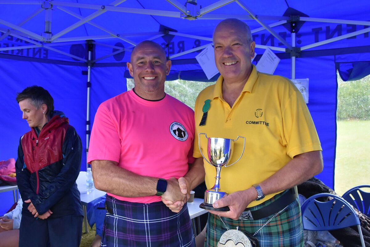 Donald McKelvie presented Tom Gilmore with the Wm Cook and Sons Trophy and the Tom Dolan Challenge Trophy for his efforts in the heavy events.