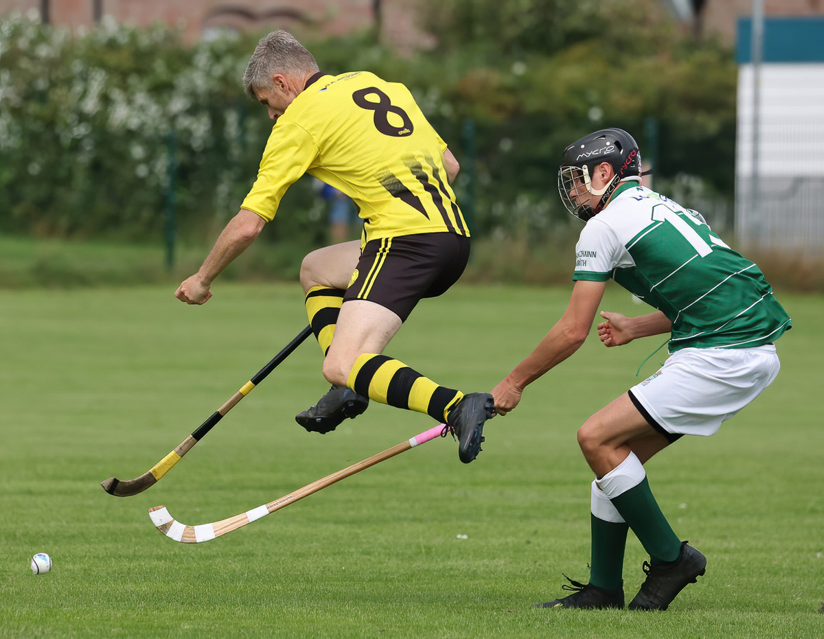 no sl t33 Ruaridh Graham Snr (Inveraray) leaps over the stick of Ryan Cameron (Beauly)