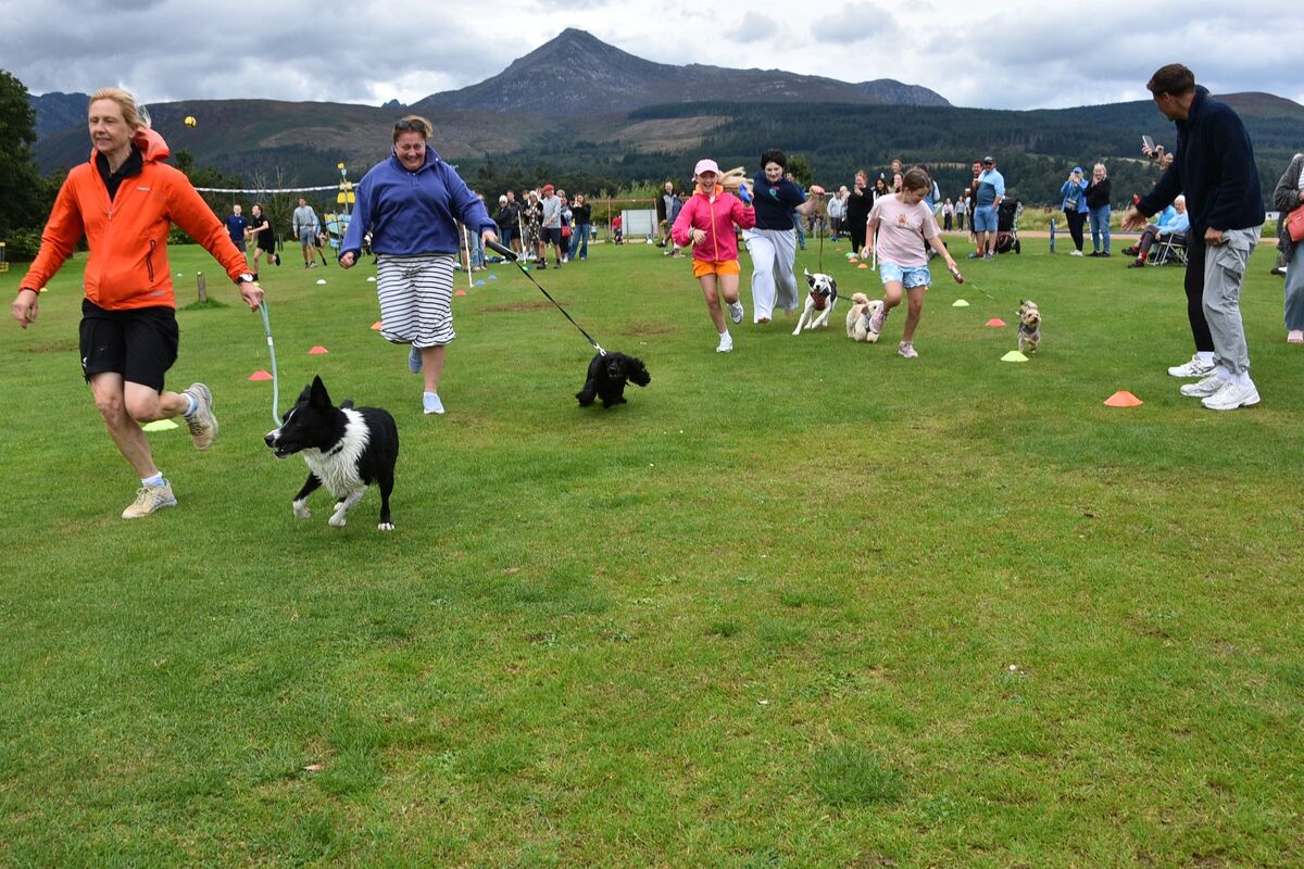 Dogs and their owners compete in the “doggy” race.