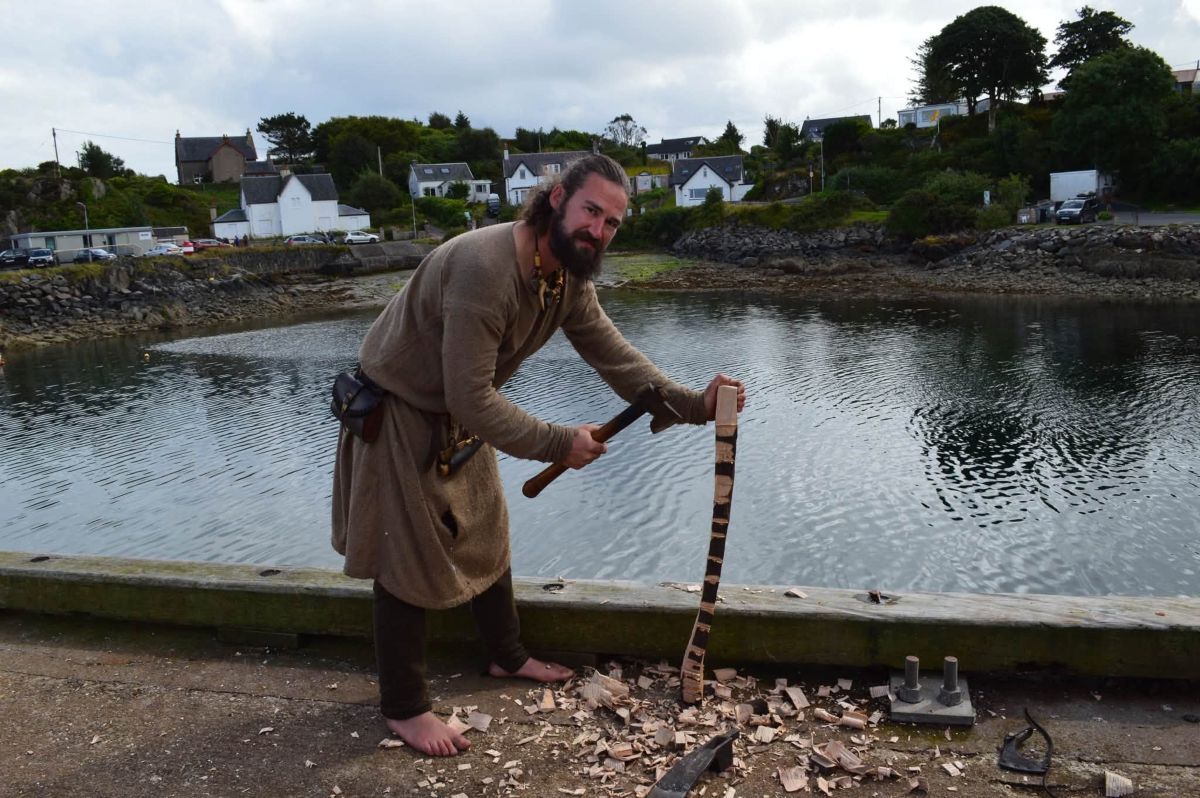 A crew member demonstrates traditional woodworking during Brioc’s visit to Carradale. Photograph: Kyle Gosling.