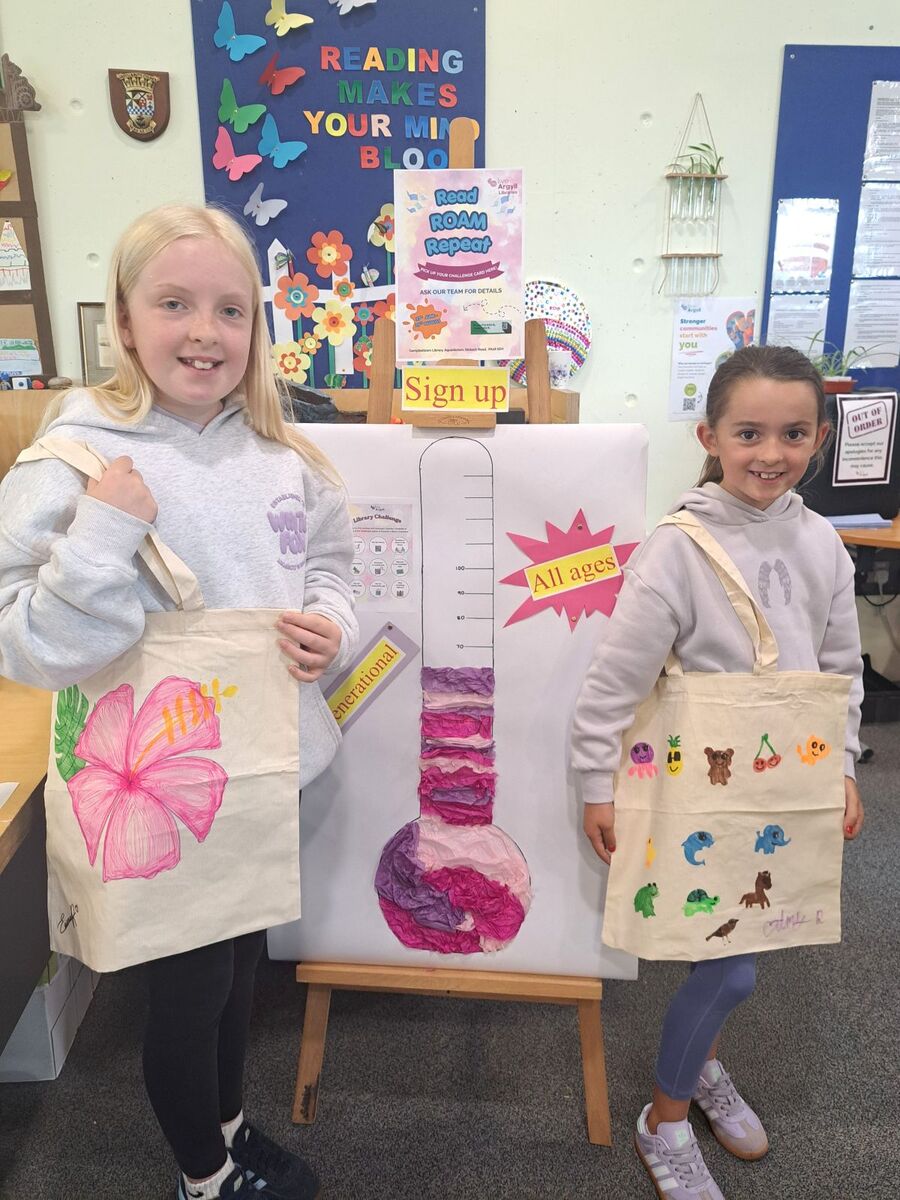 Showing off their creations after the tote bag craft session.