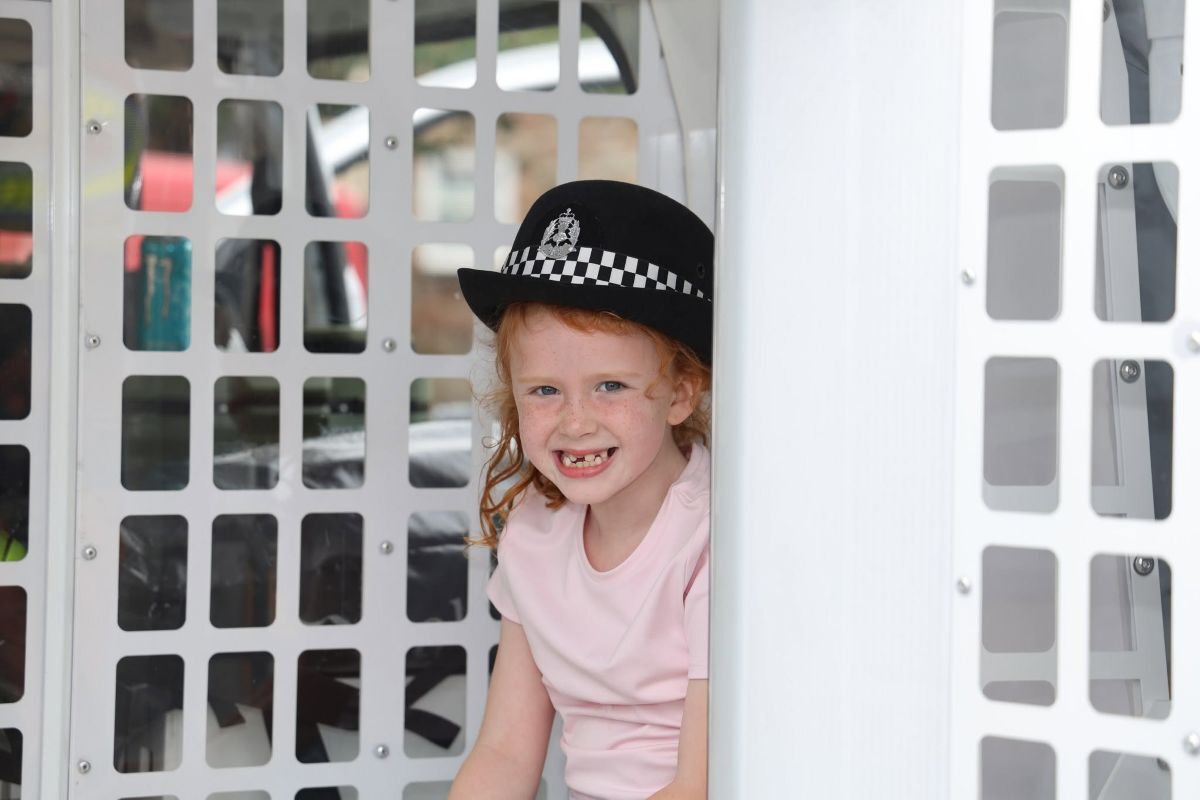 Addison Moore takes a seat in the back of a police van. Photograph: Kenny Craig.
