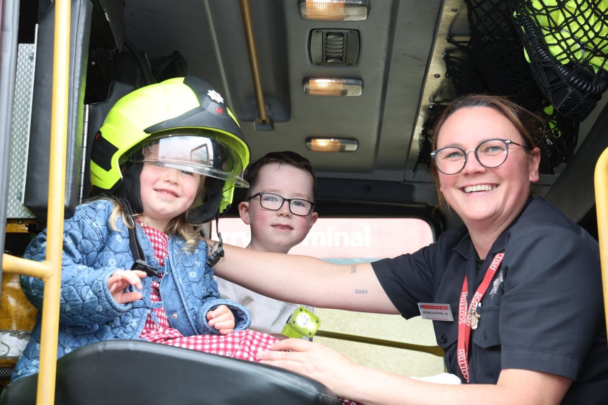 Firefighter Michelle McMillan shows Eva Johnson, who was celebrating her third birthday, and her big brother around a fire engine. Photograph: Kenny Craig.