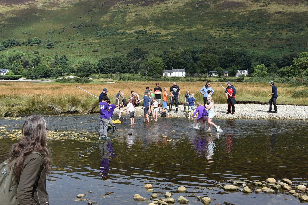 Children took great delight in helping to retrieve the ducks after the duck derby.