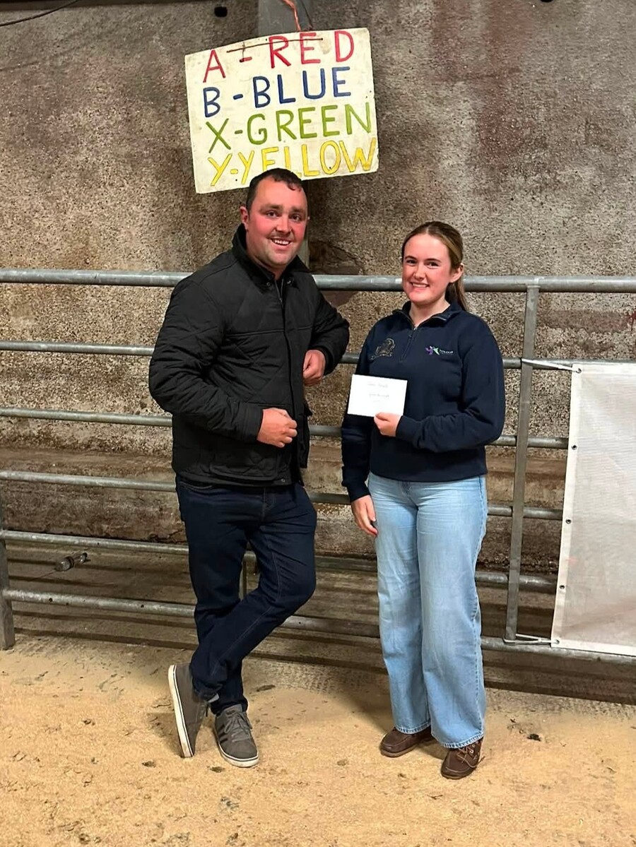 Heather Millar, right, presents James Russell with his prize for correctly guessing the combined weight of four lambs.