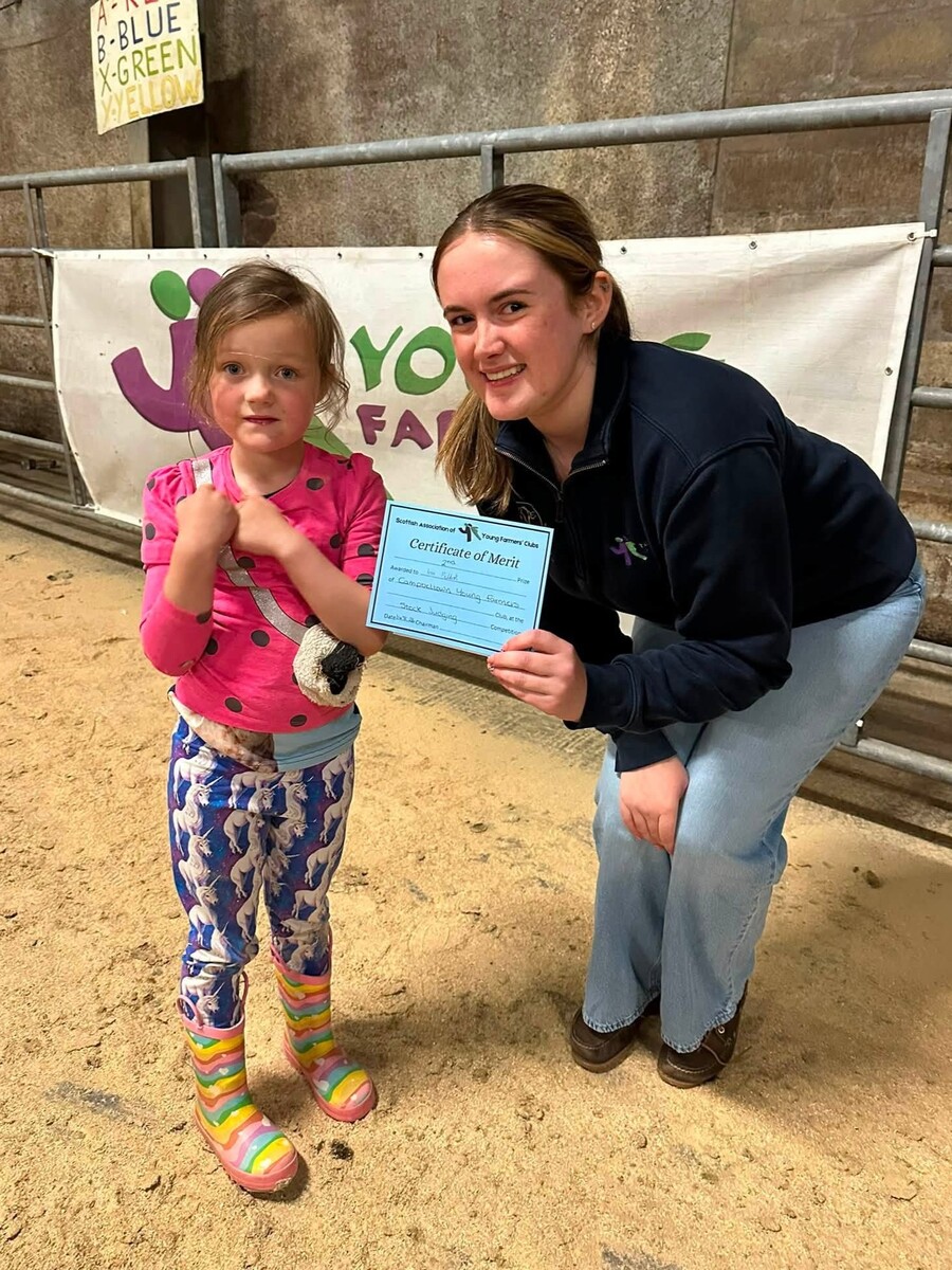 Junior runner-up Iris Paddock receives her certificate from Heather Millar. Junior runner-up Iris Paddock receives her certificate from Heather Millar.