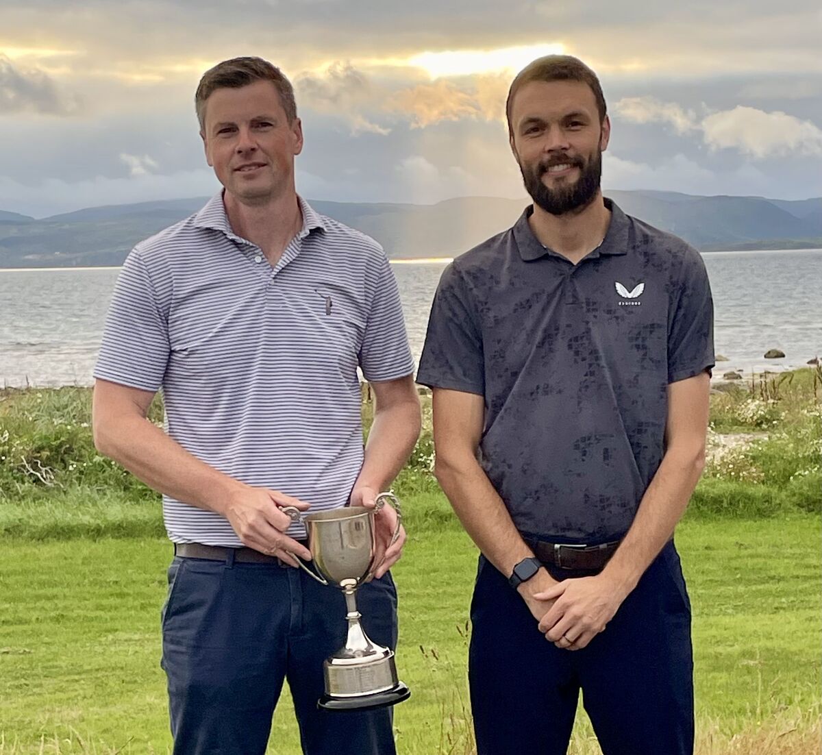 Ewan McKinnon won the Arran Golfers Association Champion of Champions title for the 12th time. Congratulating him was runner up Matt Dobson. Photograph: BGC. Ewan McKinnon won the Arran Golfers Association Champion of Champions title for the 12th time. Congratulating him was runner up Matt Dobson. Photograph: BGC.