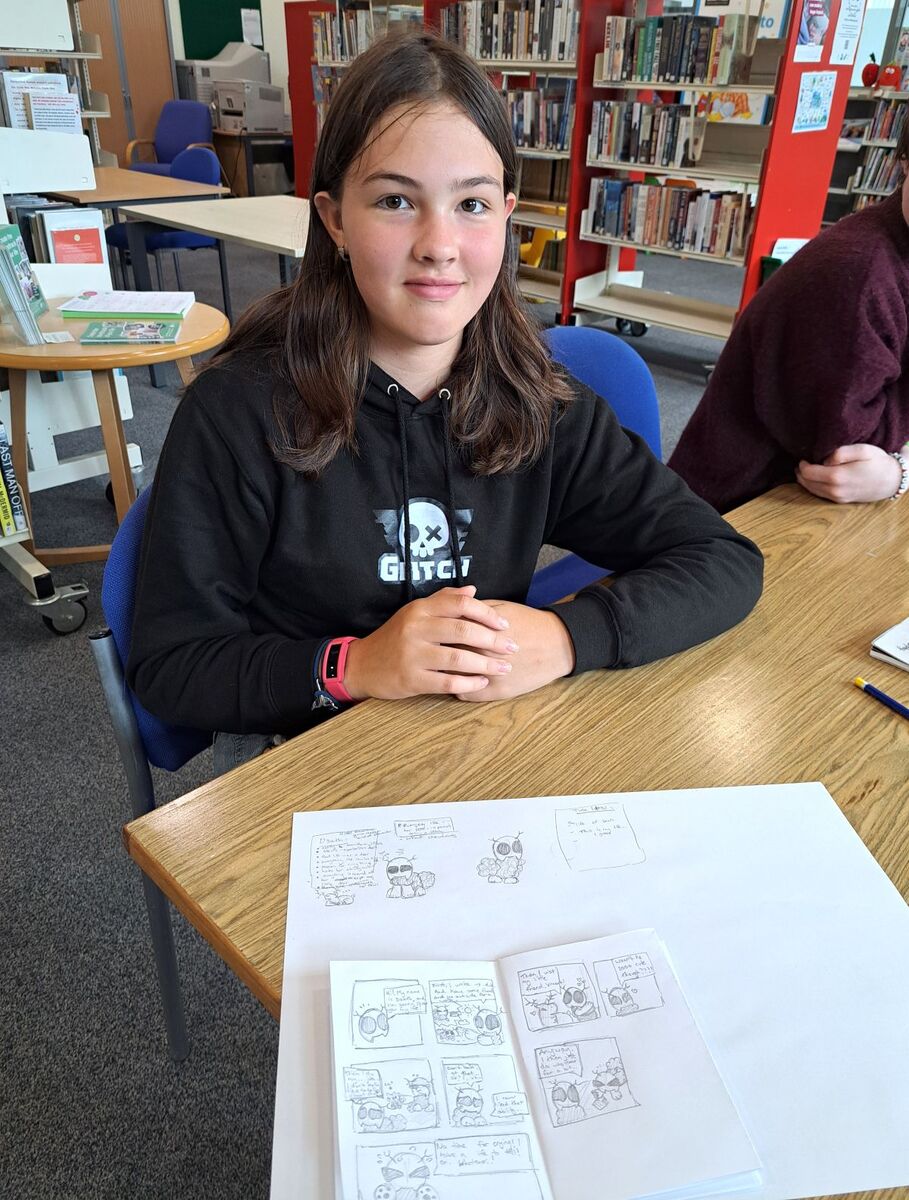 One of the young creators shows off her comic work at Campbeltown Library. One of the young creators shows off her comic work at Campbeltown Library.