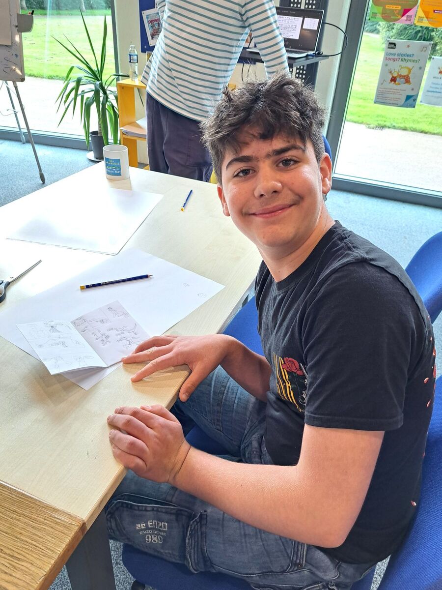 A young participant gets to work on his eight-page mini comic during Adam Murphy’s workshop.