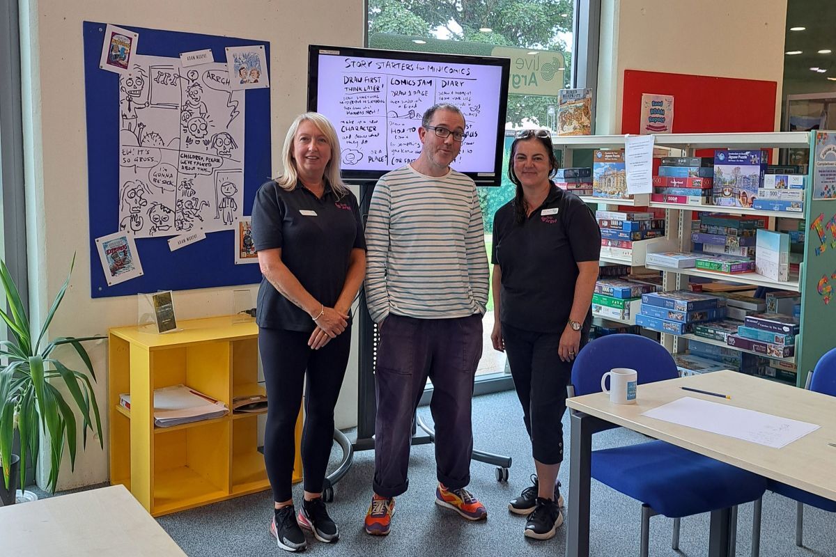 Adam Murphy, centre, with library assistant Linzi Robertson, left, and library supervisor Tracey Muscroft at Campbeltown Library.