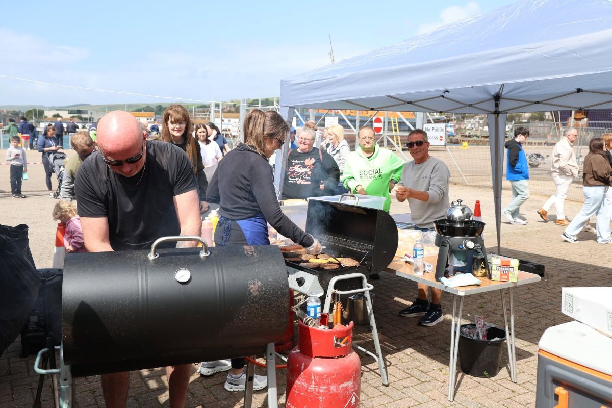 The trio were “flat out” selling burgers and hot dogs at the RNLI gala day.