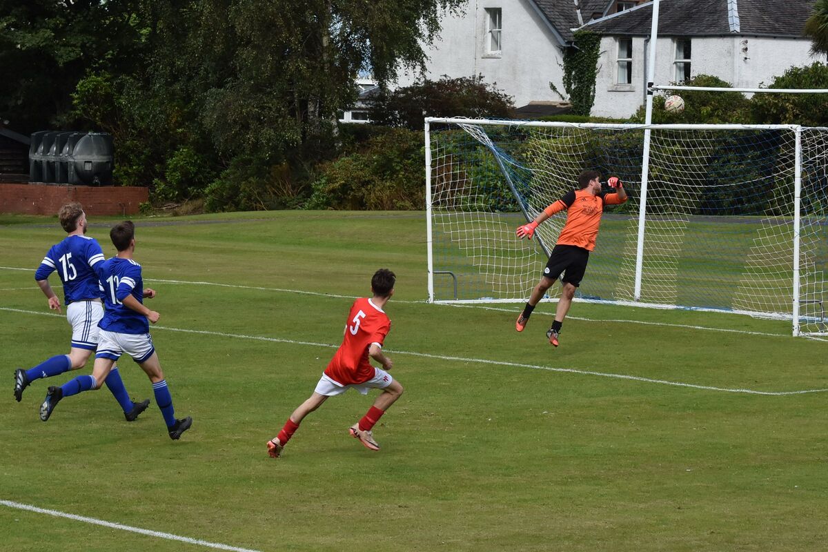Brodick keeper, Gregor Adamson bats away a Shiskine attempt at goal. Brodick keeper, Gregor Adamson bats away a Shiskine attempt at goal.