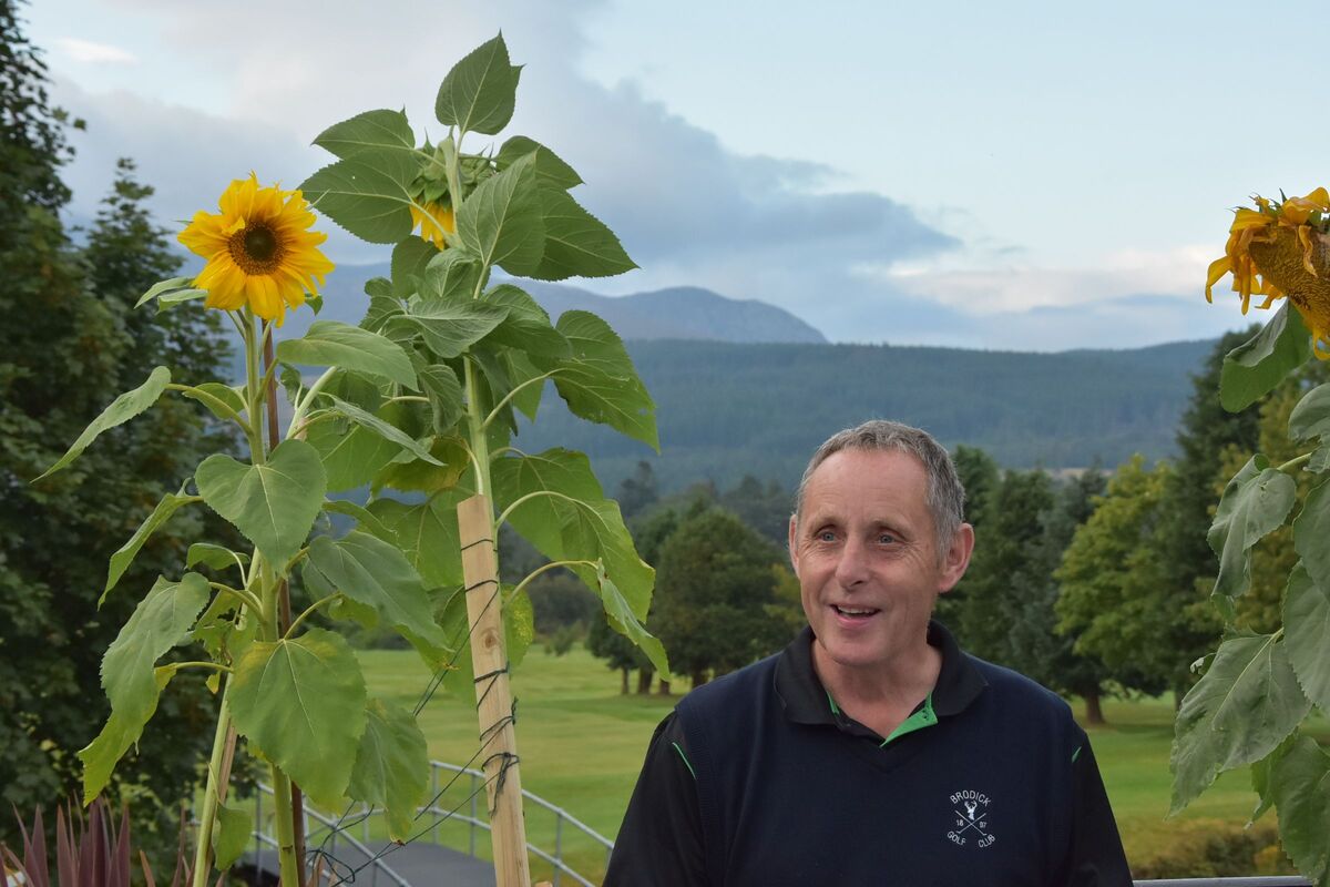 Event organiser Nicol Hume with the sunflower grown by Finn Popplewell that won the best in show prize. Event organiser Nicol Hume with the sunflower grown by Finn Popplewell that won the best in show prize.