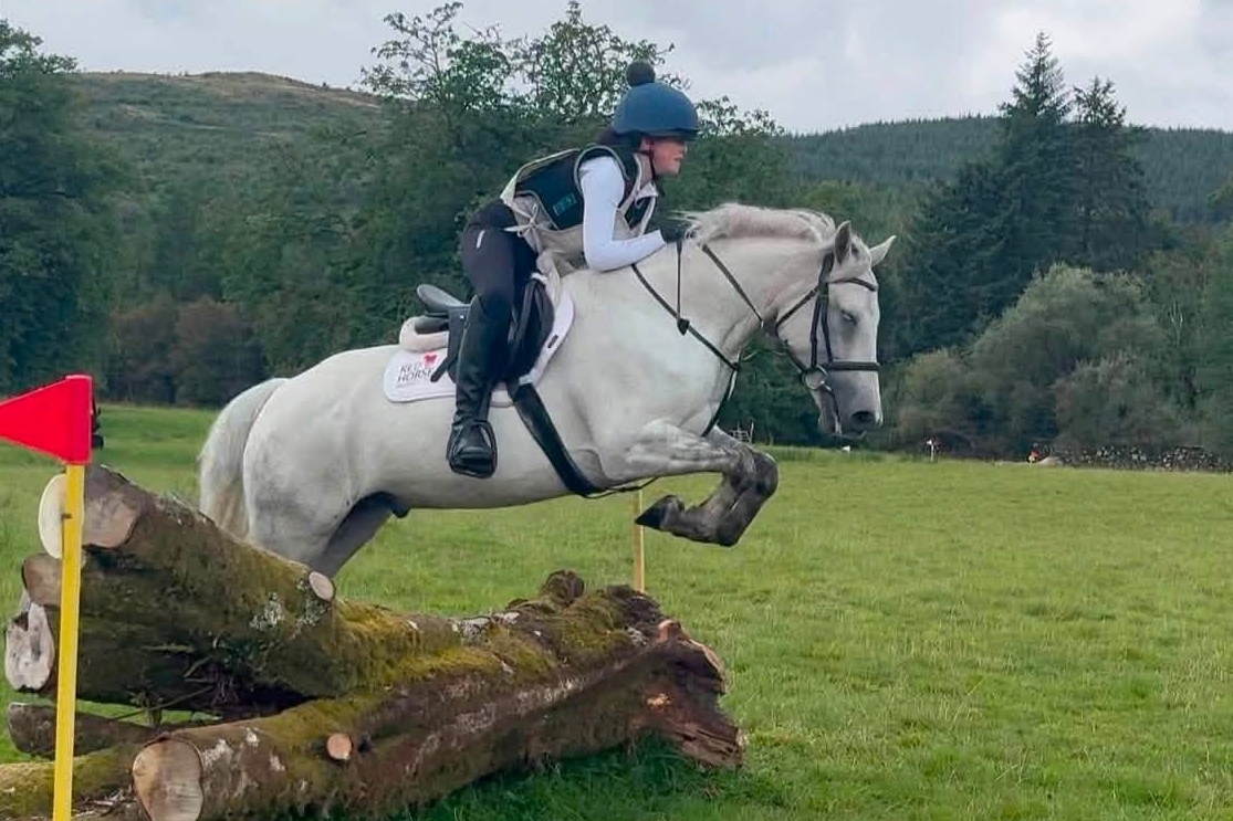 Katie Tuite and Biscuit sail over the Big Log jump. Photograph: South Argyll Pony Club