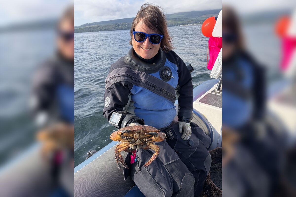 Ghost Fishing UK northern representative Emma Keeley with a large crab rescued from ghost gear in Arran waters. Photograph: Ghost Fishing UK. Ghost Fishing UK northern representative Emma Keeley with a large crab rescued from ghost gear in Arran waters. Photograph: Ghost Fishing UK.