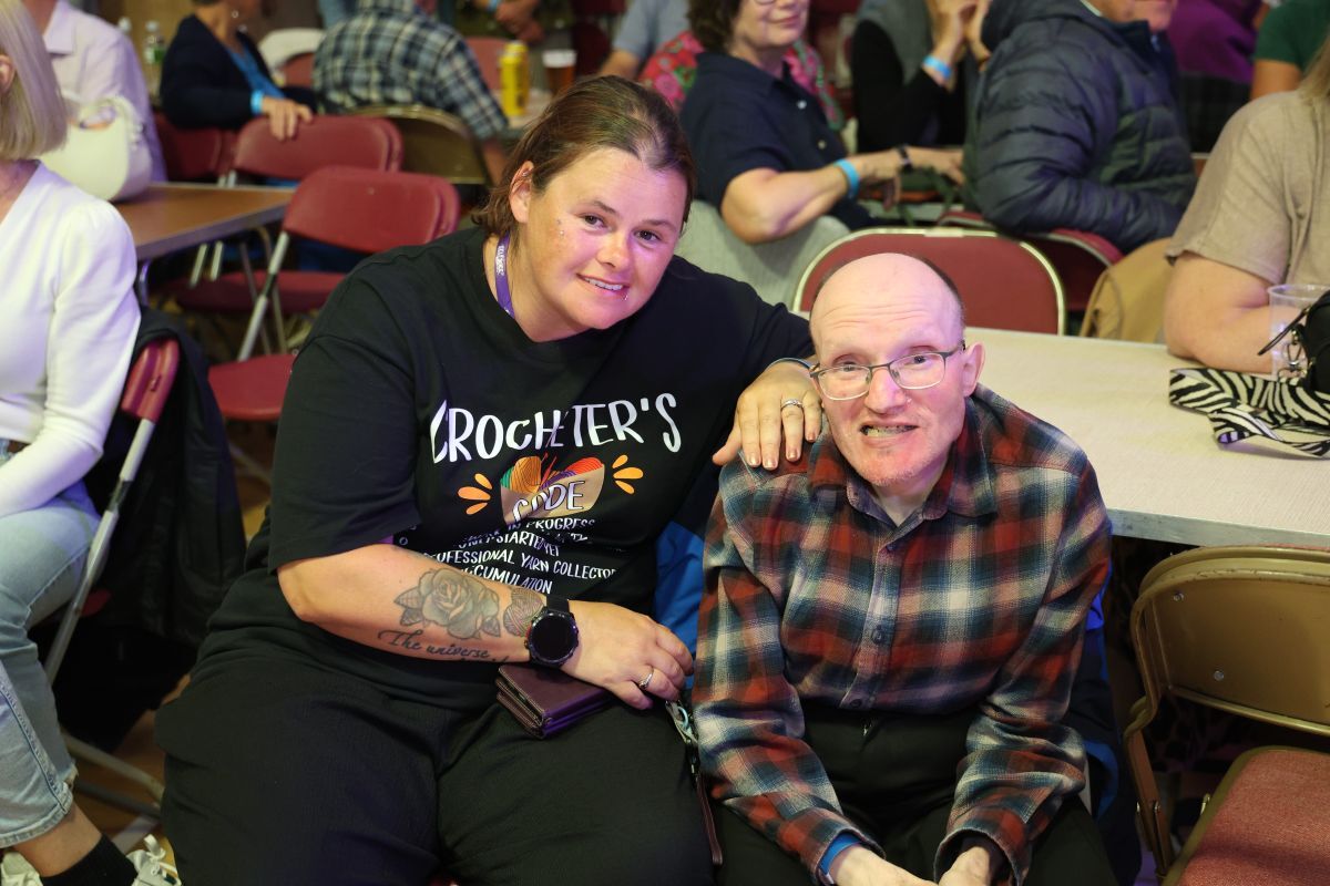 Clifford Rennie and his carer, Laura Anderson, enjoy the Ceilidh Night after a six-hour bus journey from Forfar to attend this year’s MOK Fest. Photograph: Kenny Craig.