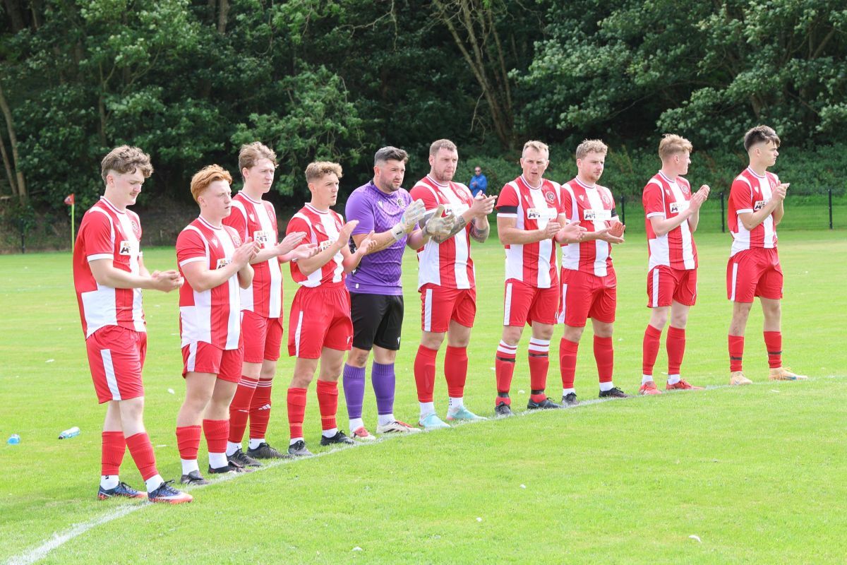 Campbeltown Pupils players join in a minute’s applause in memory of Roy Mitchell before kick-off at Kintyre Park. Photograph: Kenny Craig.
