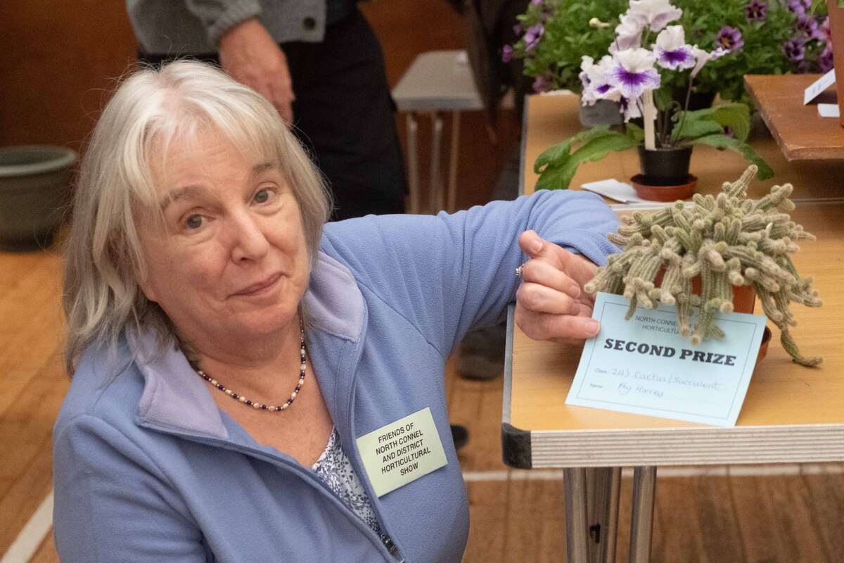 no t36 Fay Harvey with her prize winning Peanut cactus which shares its 65th birthday with the Show